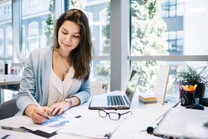 Cheerful Woman Writing a Blog